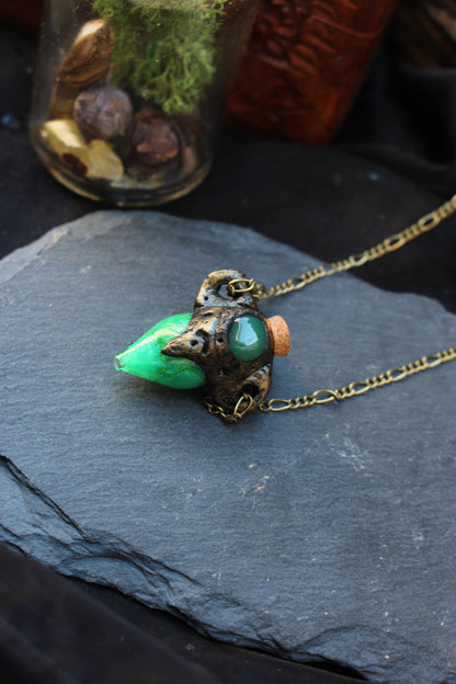 Handmade alchemy-inspired necklace featuring a glowing green potion