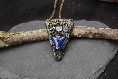 Ancient-inspired blue stone talisman necklace with an antique bronze finish