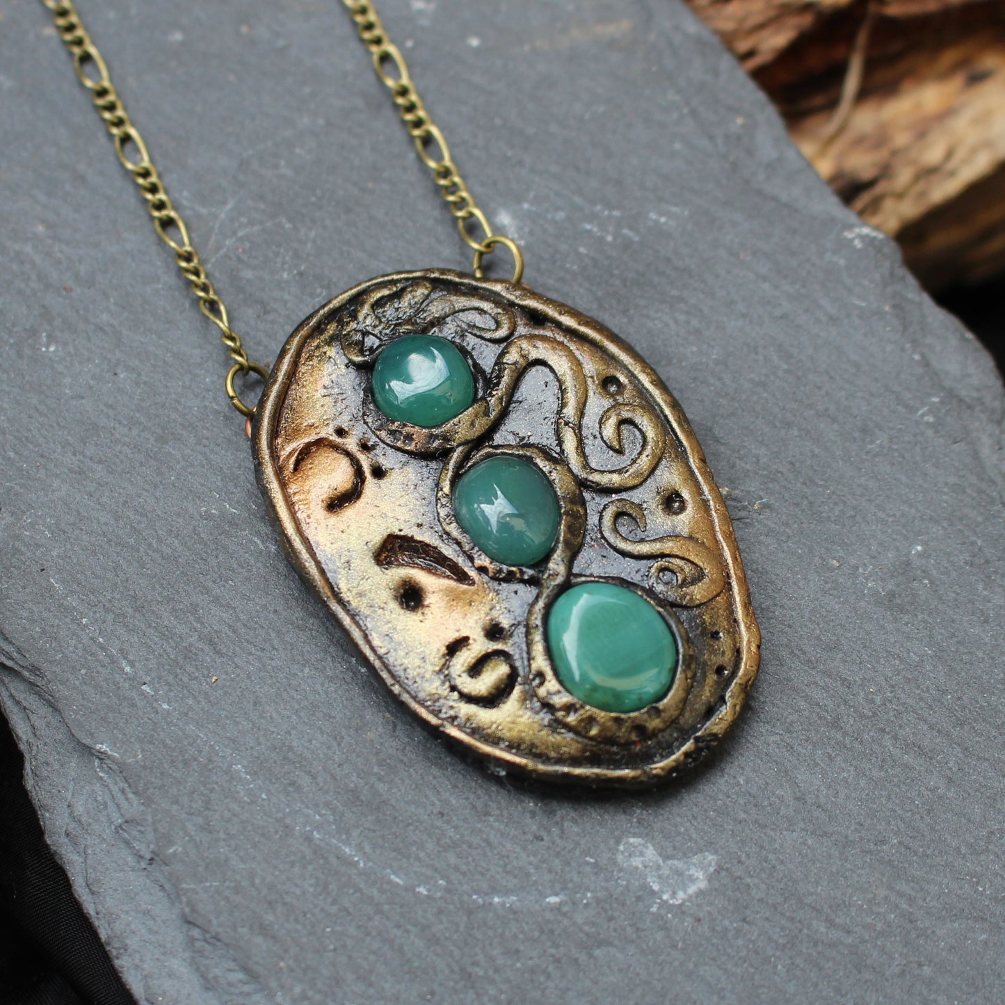 Handmade fantasy amulet with three green agate gemstones and ancient runes