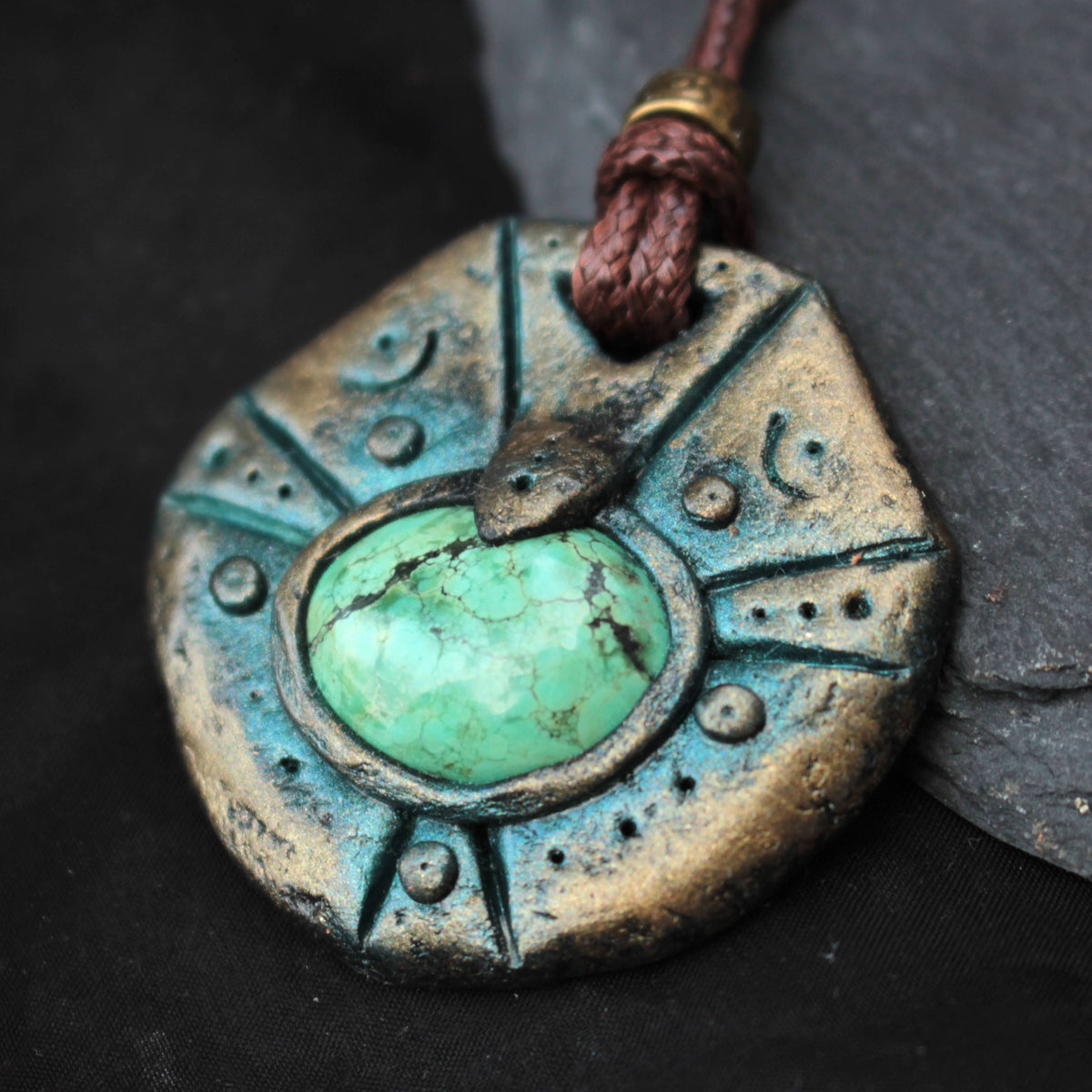 Handmade fantasy pendant with antique patina finish and green gemstone centerpiece