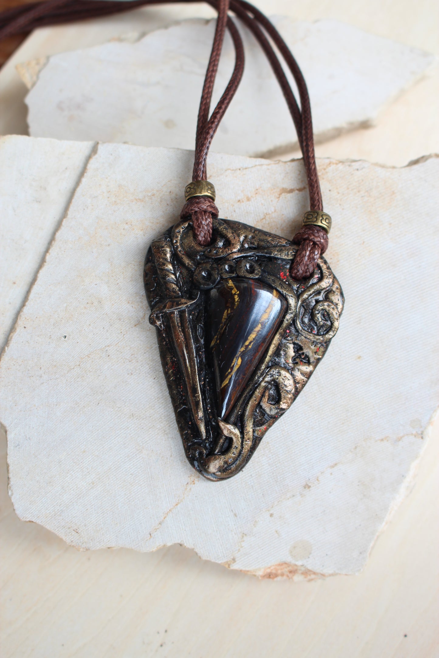 Ancient relic inspired pendant with metallic finish