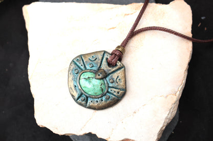 Close-up showing the textured antique patina and intricate details of the fantasy pendant