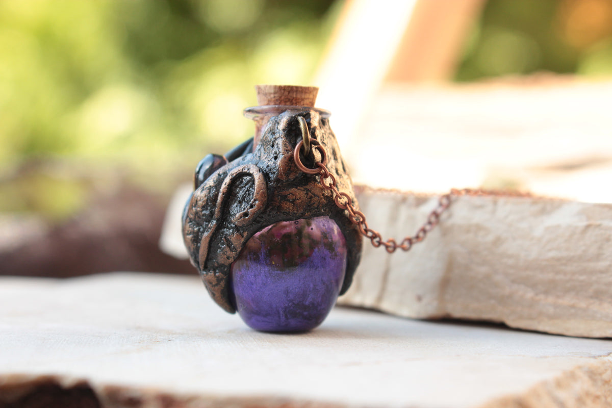 Fantasy necklace featuring a violet crystal and an antique-style potion bottle