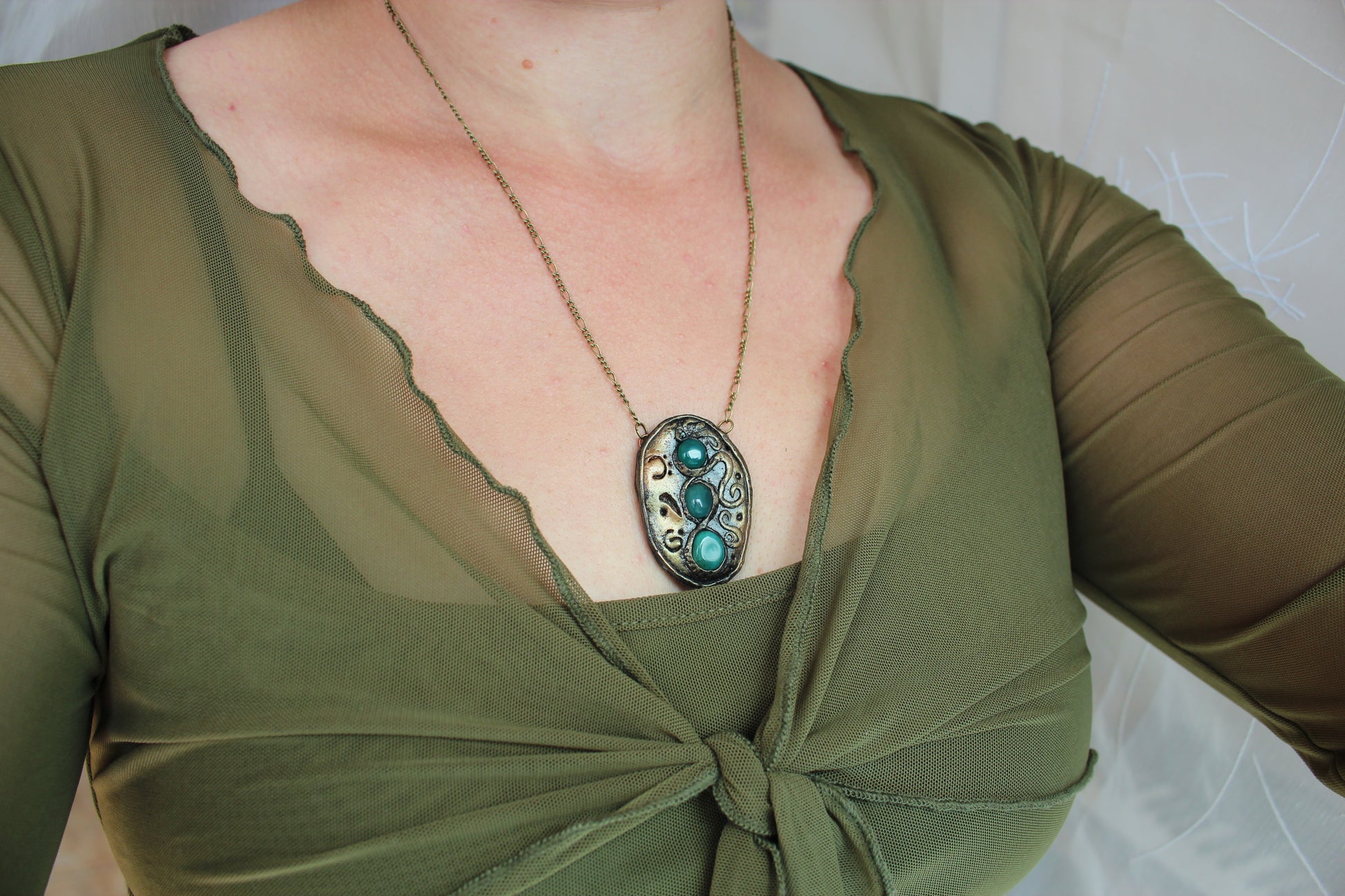Artisan fantasy necklace featuring polished green agate cabochons