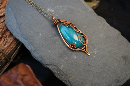 Natural blue agate pendant wrapped in handcrafted copper wire design