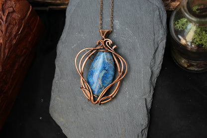 Handmade blue crazy agate gemstone pendant in intricate copper wire setting