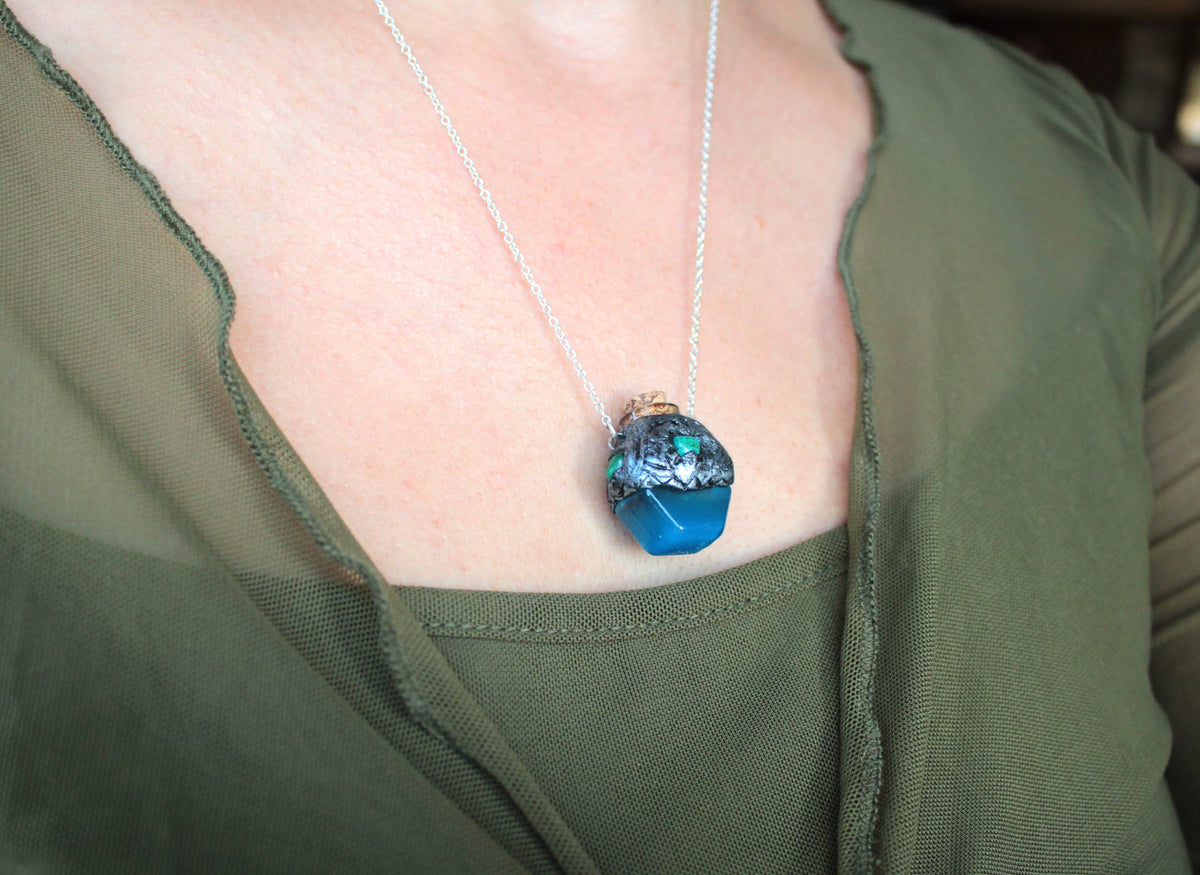Blue glowing fantasy necklace with handmade potion bottle pendant