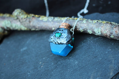 Blue glowing in the dark potion pendant with bronze details and green accents
