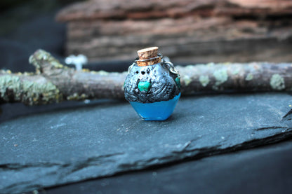Small blue magical vial pendant with antique bronze finish
