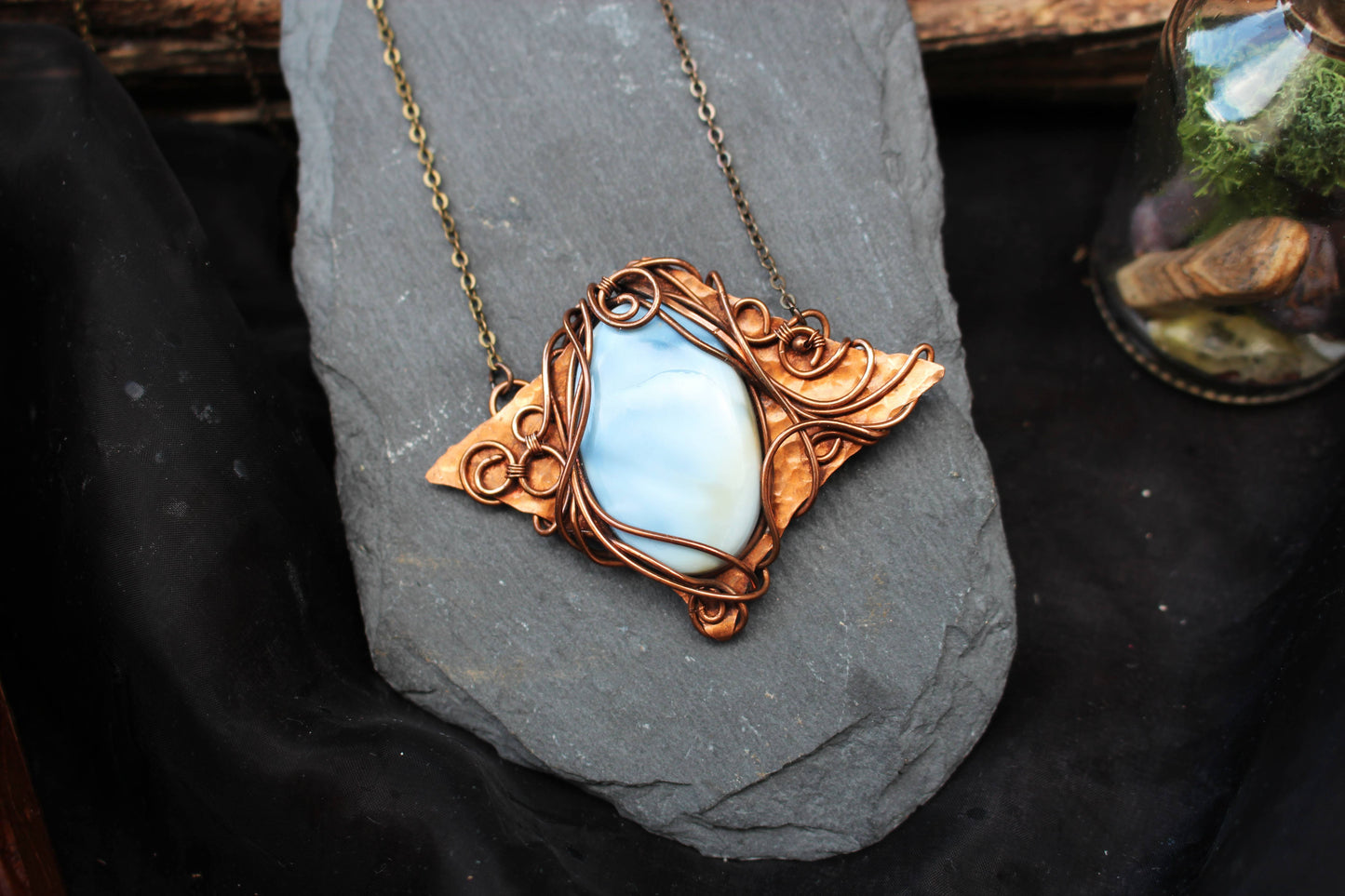 Elegant blue opal crystal pendant with copper wire wrapping