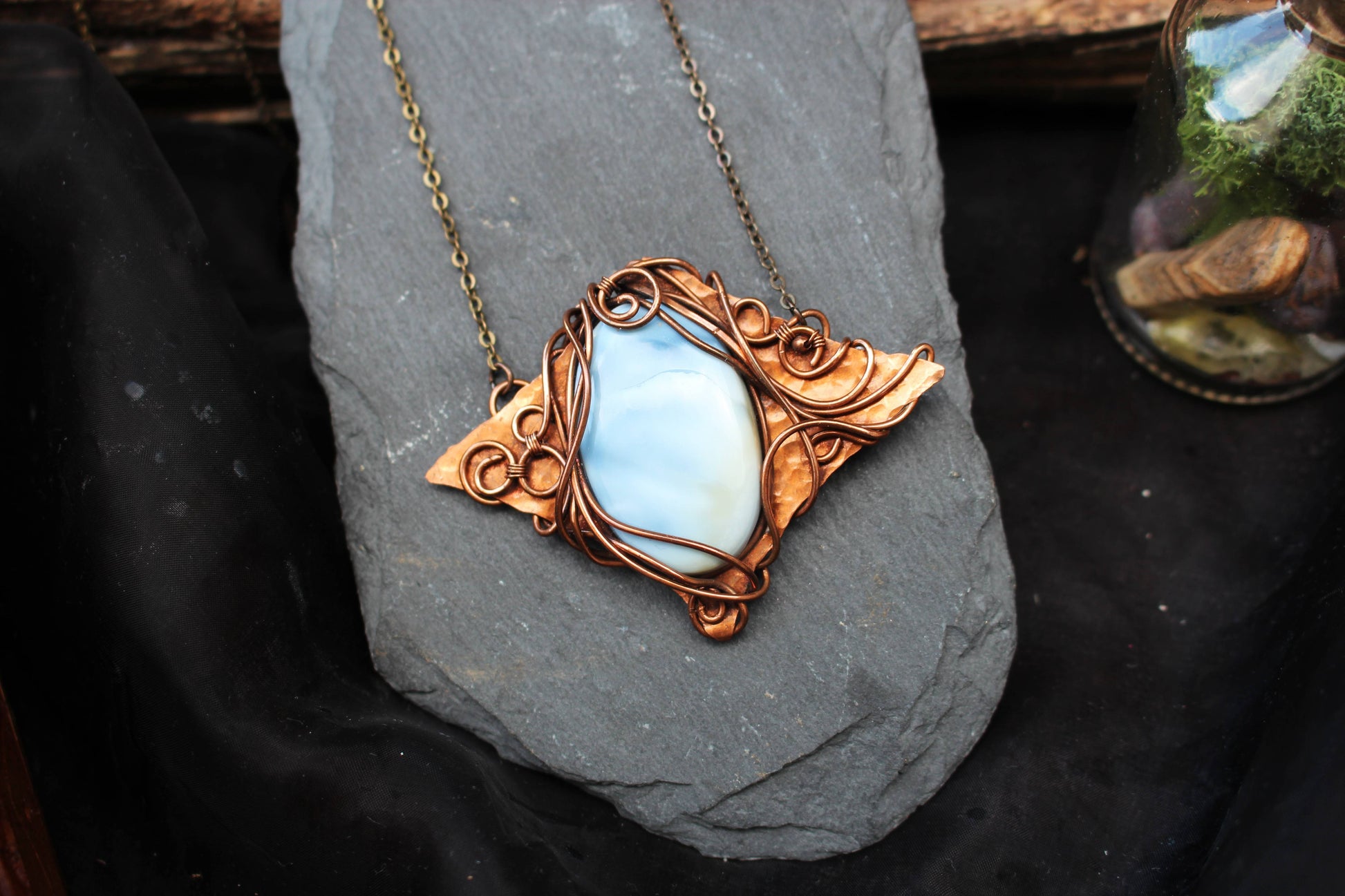 Elegant blue opal crystal pendant with copper wire wrapping
