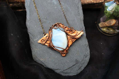 Elegant blue opal crystal pendant with copper wire wrapping
