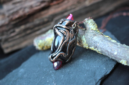 Fantasy necklace featuring a broken red crystal held together by two whole crystals