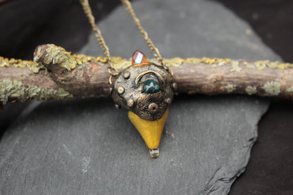 Bronze forest amulet with green gemstone and crystal detail