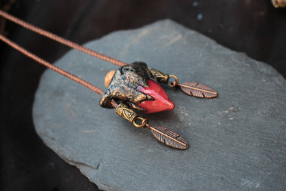 Detailed view of the crimson potion pendant and bronze metallic accents