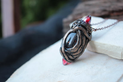 D&D-inspired fantasy necklace featuring three red crystals and a mystical handmade design