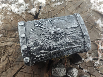 Close up of dragon themed clay decoration on wooden box
