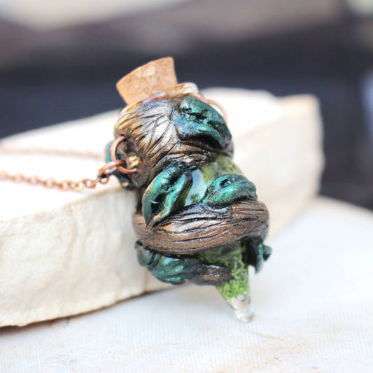 Handmade druid moss potion necklace with a tiny bottle and natural forest-inspired details