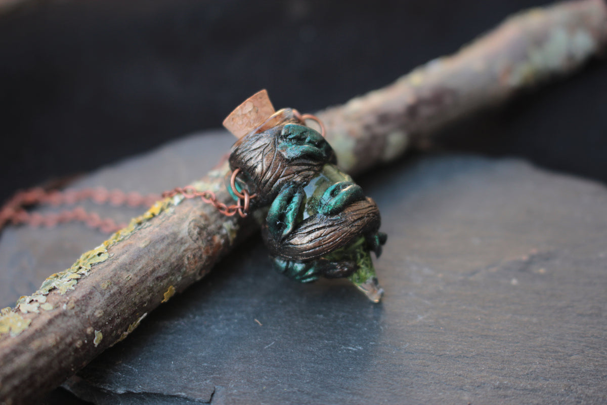 Druid-inspired fantasy necklace with a miniature moss-filled potion bottle
