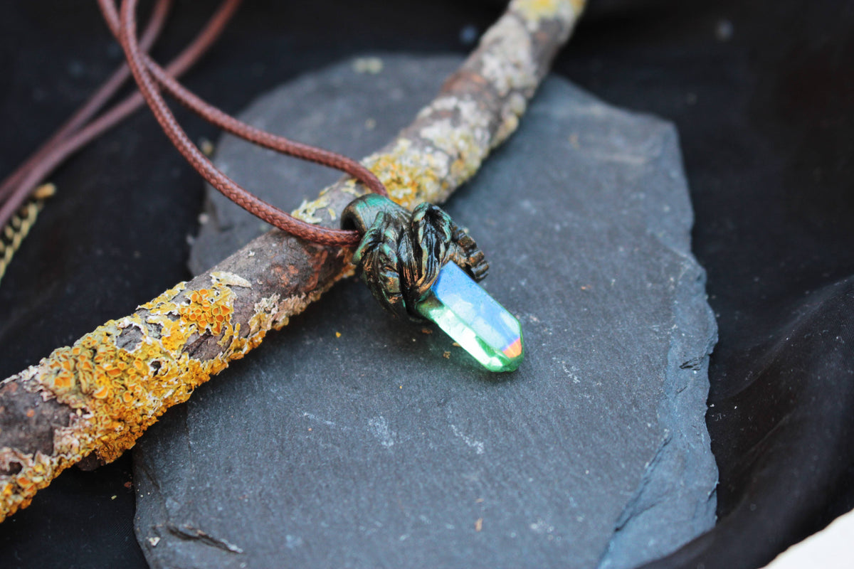 Close-up of the Elarwyn Crystal fantasy pendant with green and blue iridescent details