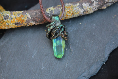 Close-up of the green and blue crystal pendant inspired by an enchanted forest