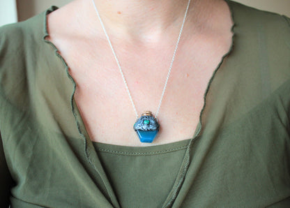 Enchanted blue potion pendant with forest-inspired handmade details