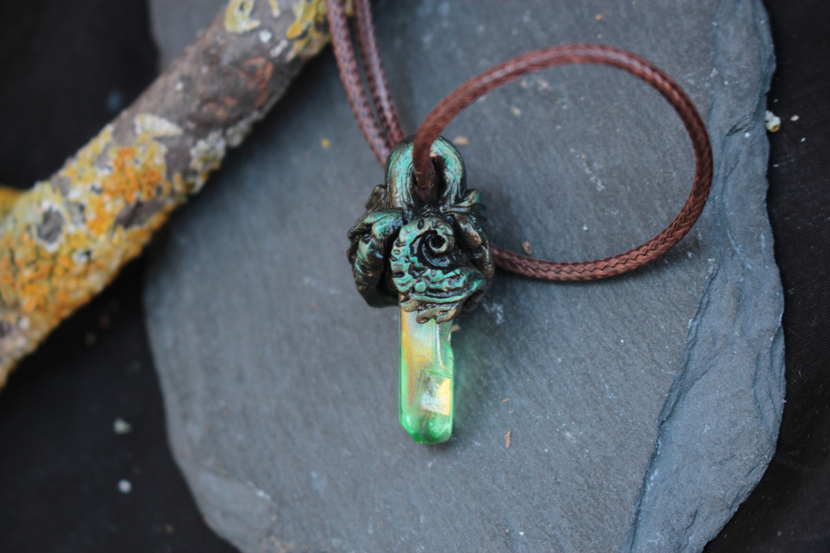 Crystal necklace photographed in a dark enchanted forest setting