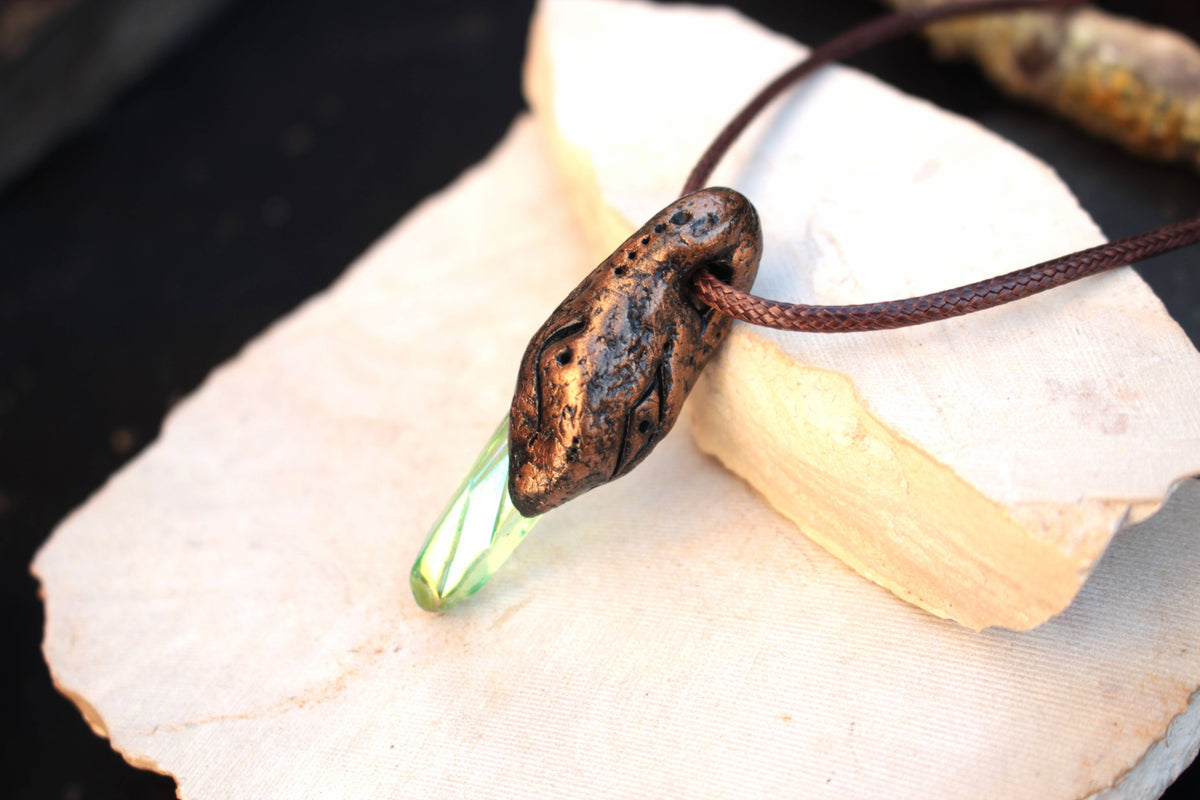 Enchanted forest pendant with a luminous green center