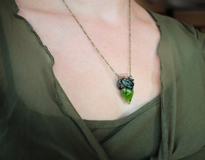 Enchanted moss vial jewelry with sculpted bronze details and chain