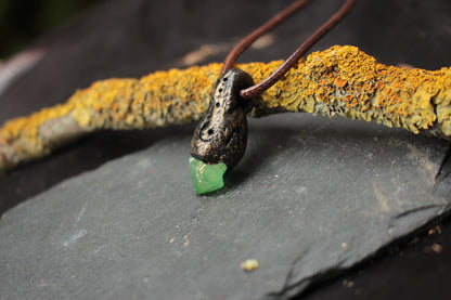 Fantasy necklace featuring a mystical green crystal inspired by nature