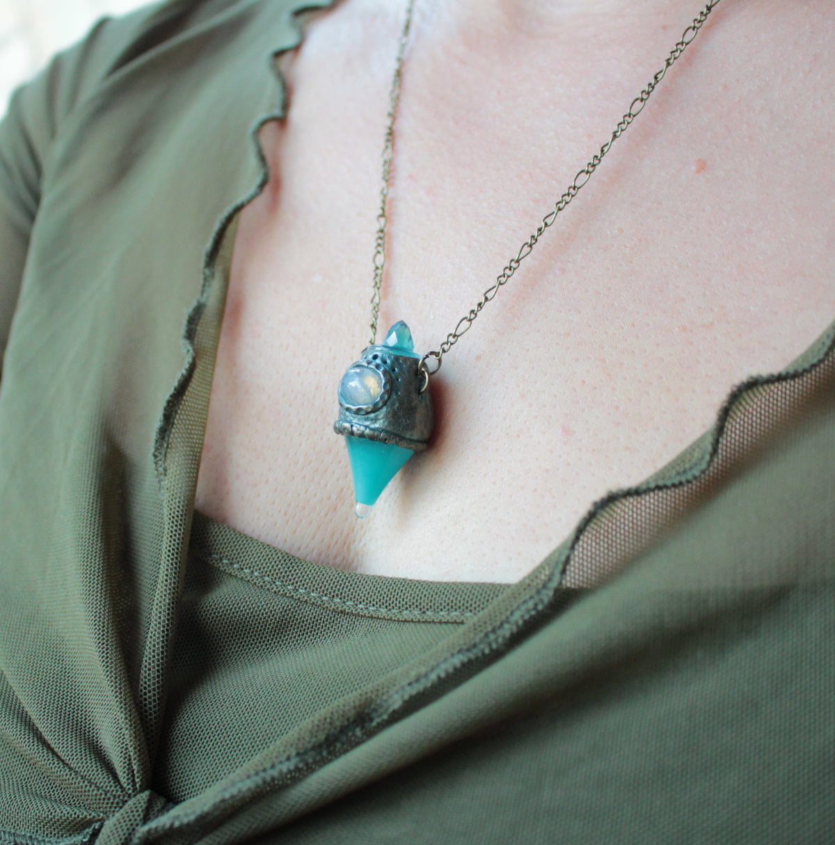 Enchanted potion bottle pendant necklace with glowing turquoise details