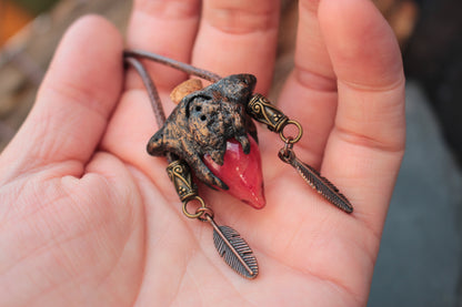 Close up view of a magical red potion relic necklace with bronze details
