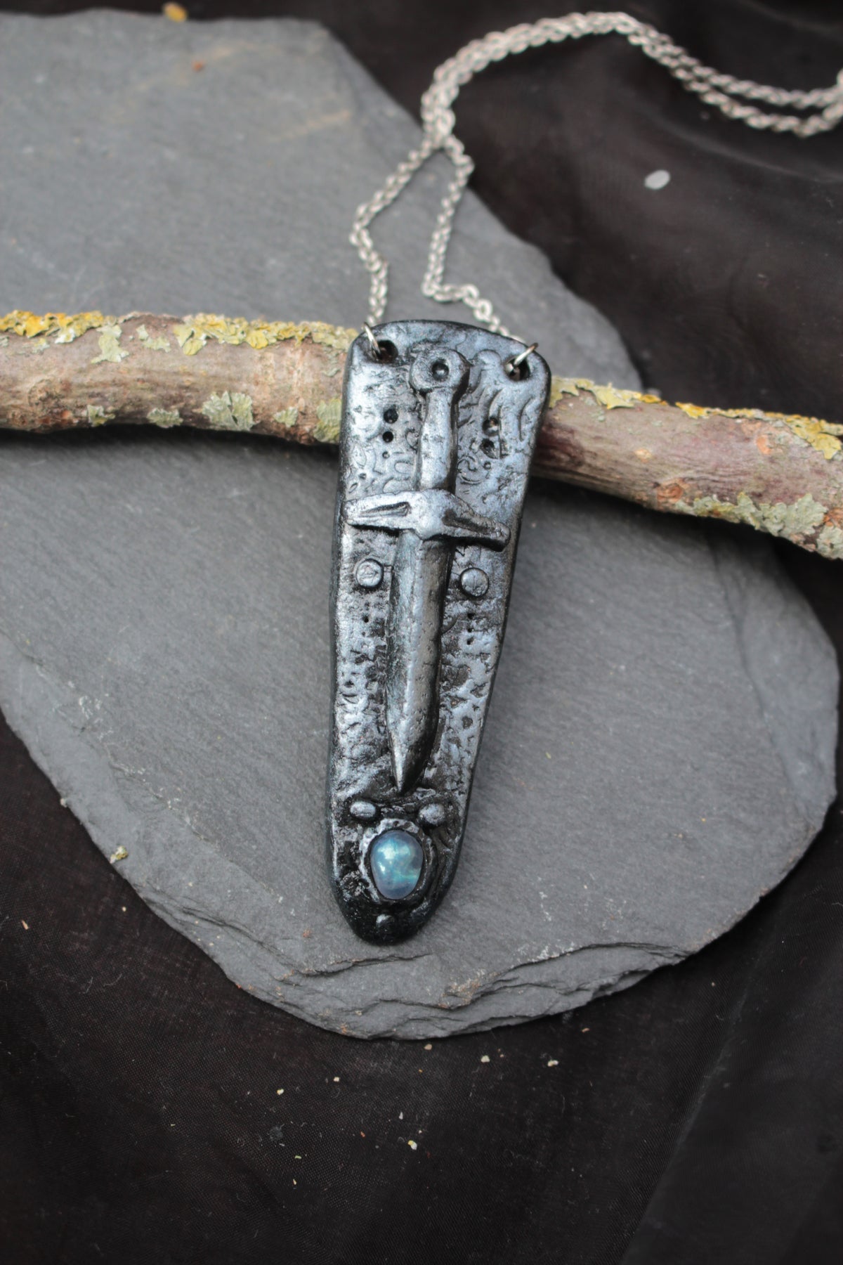 Enchanted fantasy sword jewelry with a mystical gemstone