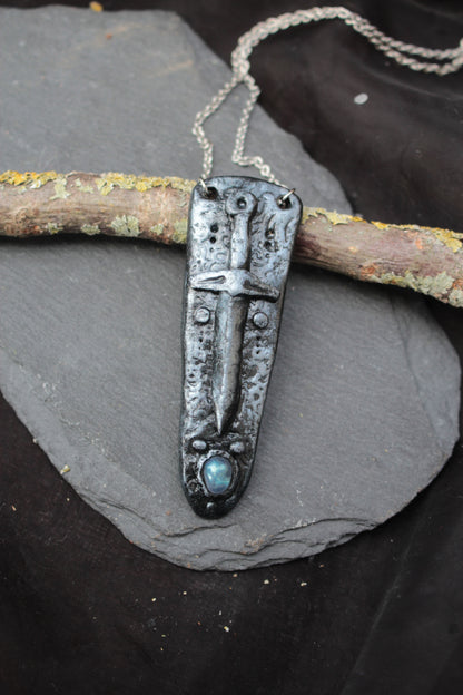 Enchanted fantasy sword jewelry with a mystical gemstone
