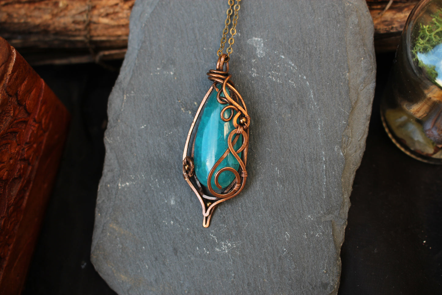 Blue agate gemstone pendant handcrafted with intricate copper wire wrapping