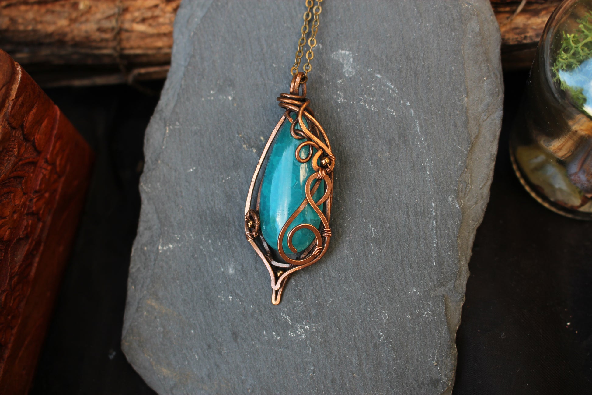 Blue agate gemstone pendant handcrafted with intricate copper wire wrapping