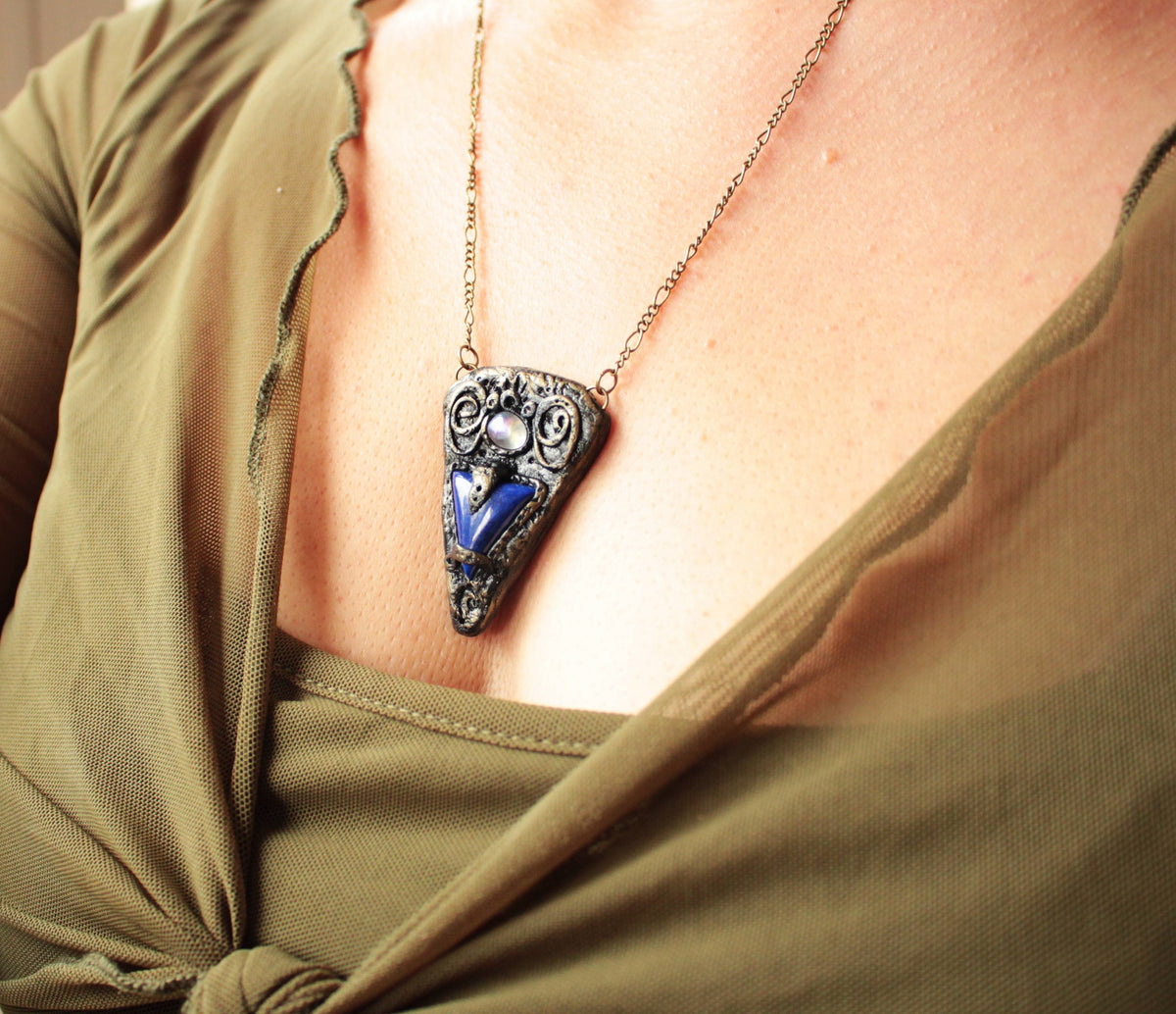 Handmade fantasy blue gemstone pendant with an aged antique appearance