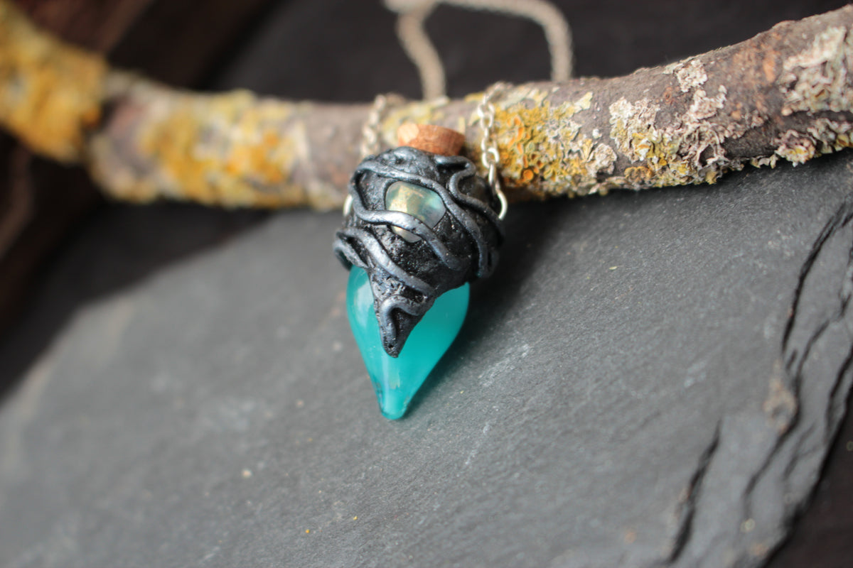 Handmade turquoise potion bottle pendant worn as a fantasy necklace