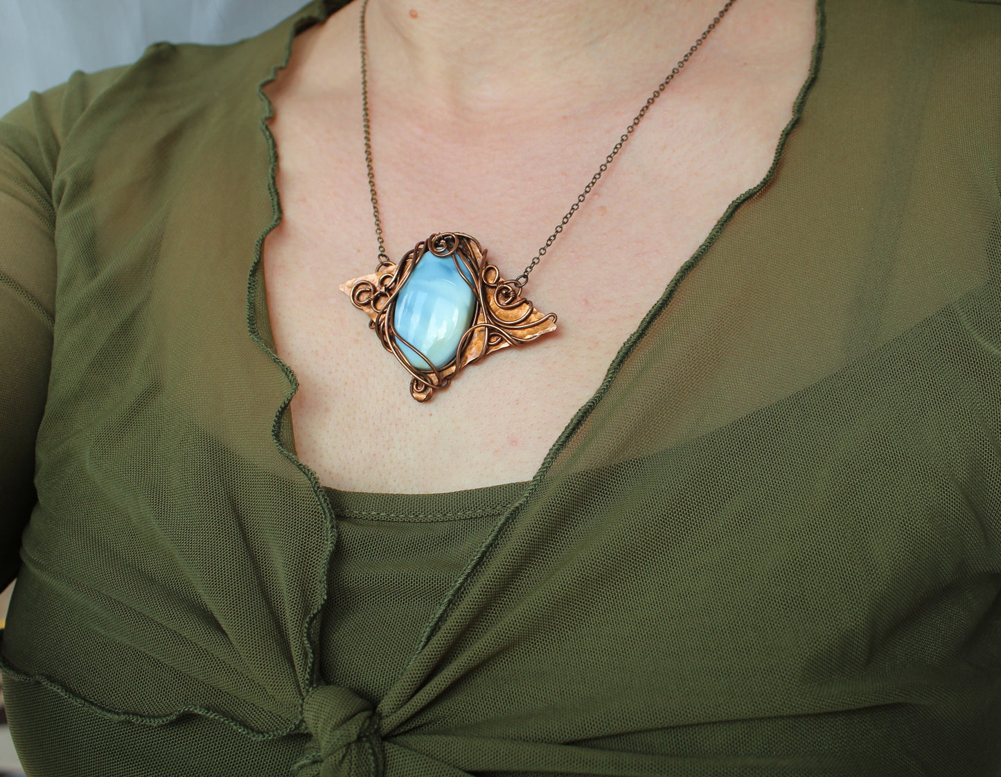 Handmade fantasy style blue opal pendant necklace crafted with intricate copper wire wrapping