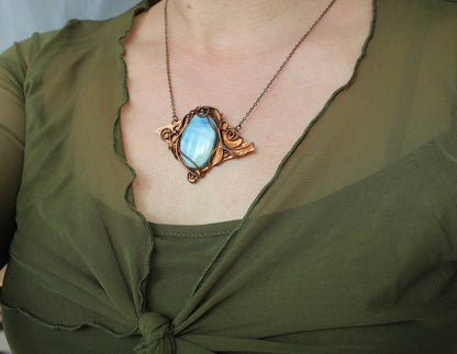 Handmade fantasy style blue opal pendant necklace crafted with intricate copper wire wrapping