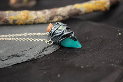 Handmade fantasy jewelry featuring a turquoise glowing potion bottle