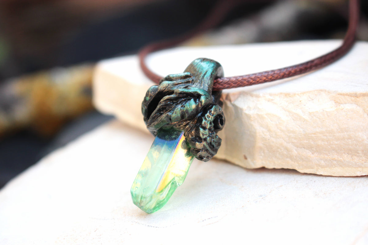 Nature-inspired fantasy necklace featuring a colorful luminous crystal