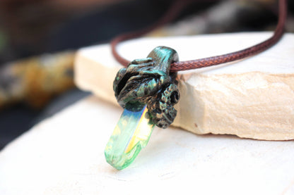 Nature-inspired fantasy necklace featuring a colorful luminous crystal