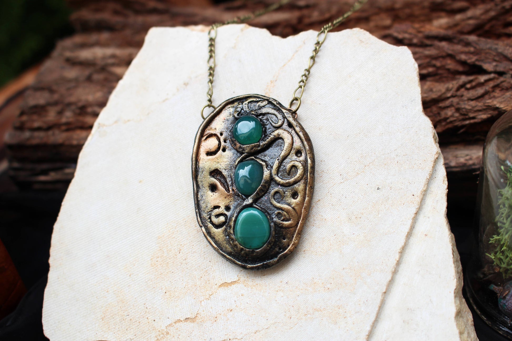 Handmade fantasy pendant decorated with three natural green agate stones