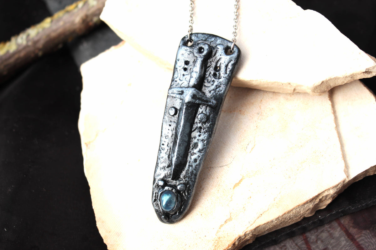 Fantasy RPG-inspired sword necklace with gemstone detail