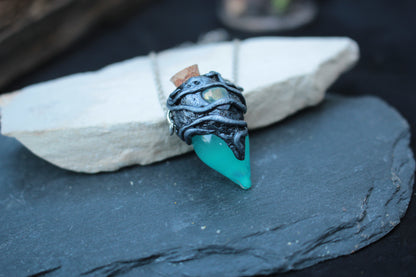 Turquoise glass vial pendant with fluorescent green glow