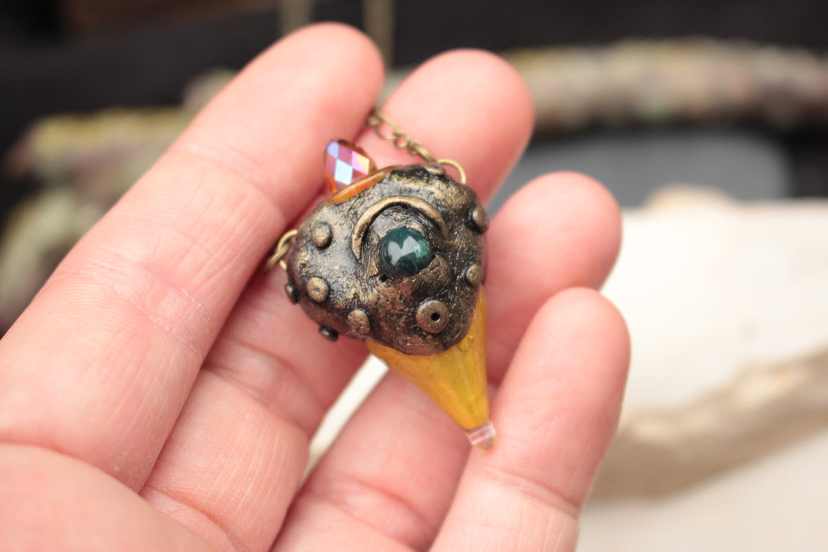 Fantasy forest amulet necklace with green stone and golden details
Title: Enchanted Forest Pendant