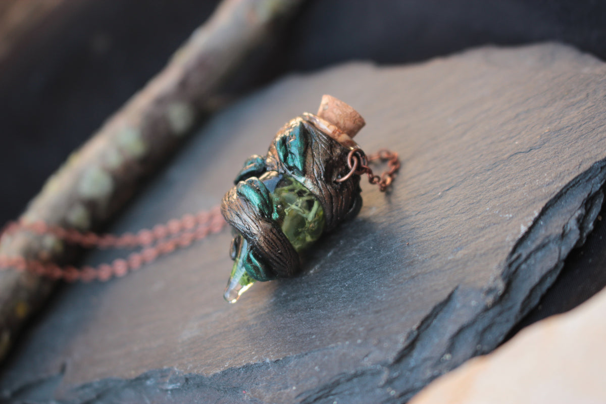 Handmade forest-inspired potion necklace with a tiny decorative bottle