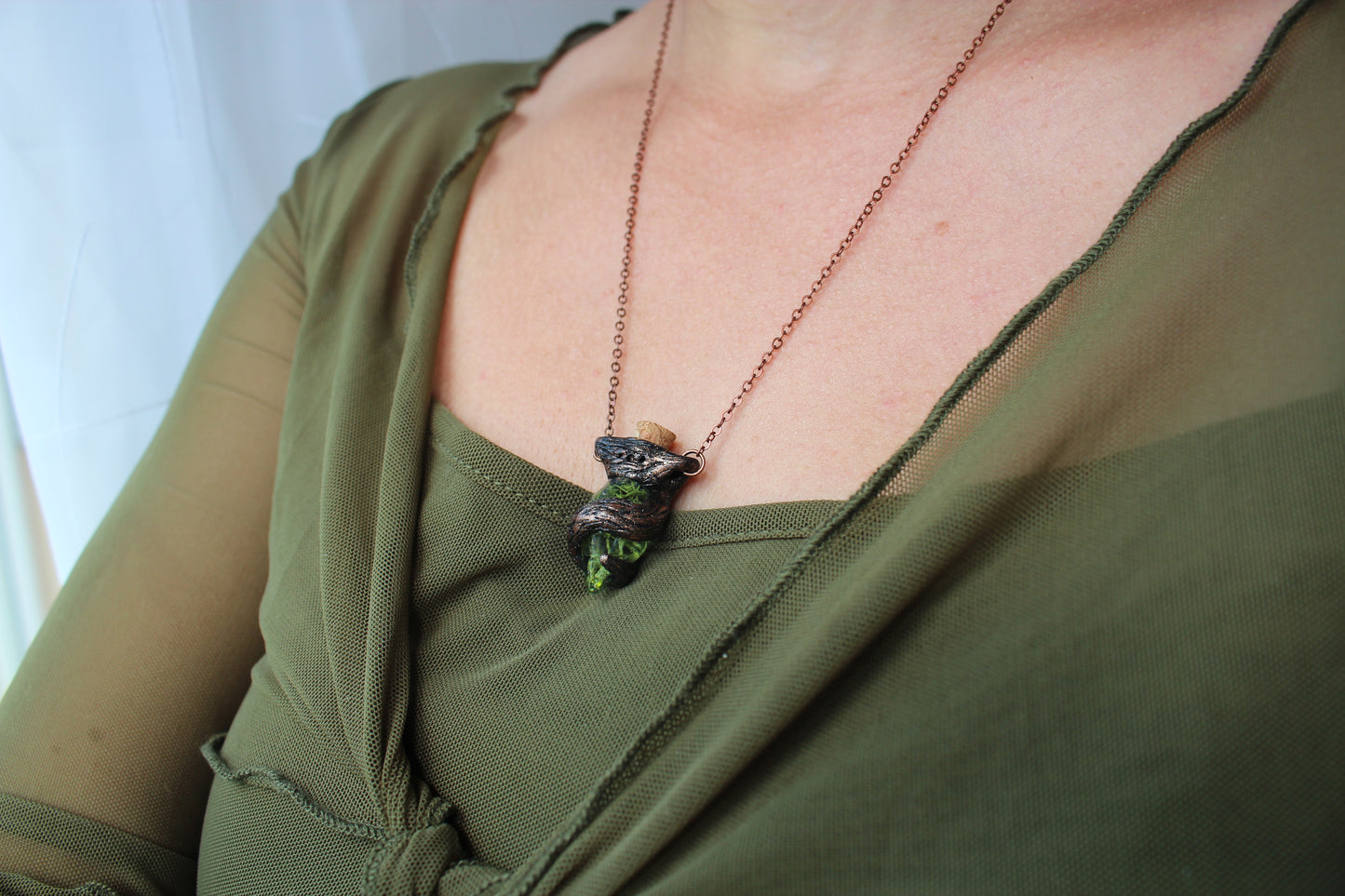 Model wearing the handmade Forest Witch necklace with a moss-filled glass potion pendant, highlighting its woodland fantasy style and everyday fit