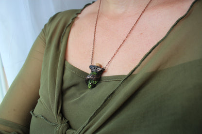 Model wearing the handmade Forest Witch necklace with a moss-filled glass potion pendant, highlighting its woodland fantasy style and everyday fit